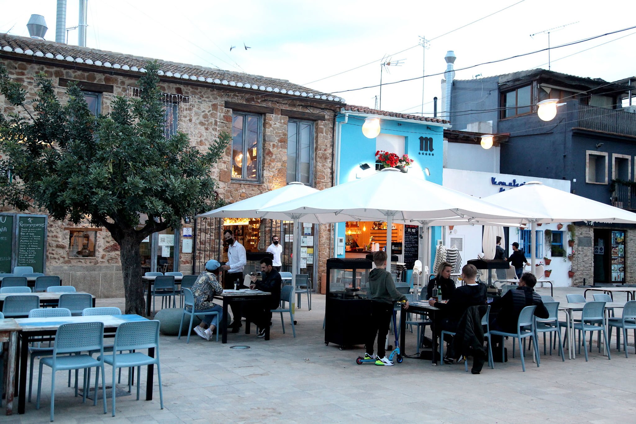 people dining on terraces in denia