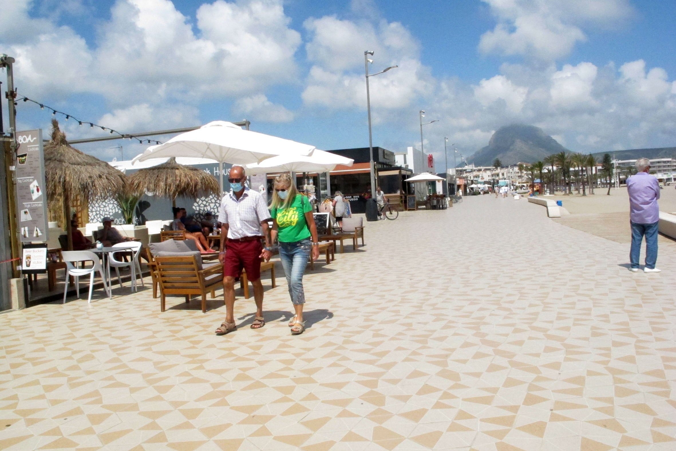 personas paseando por la playa del arenal