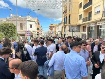 Multitud de personas congregadas en una calle decorada de Benissa durante las fiestas patronales de día.