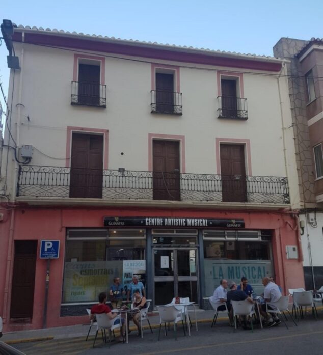 Imagen: Vista exterior del edificio del Centre Artístic Musical en Pedreguer con su cafetería en la planta baja.