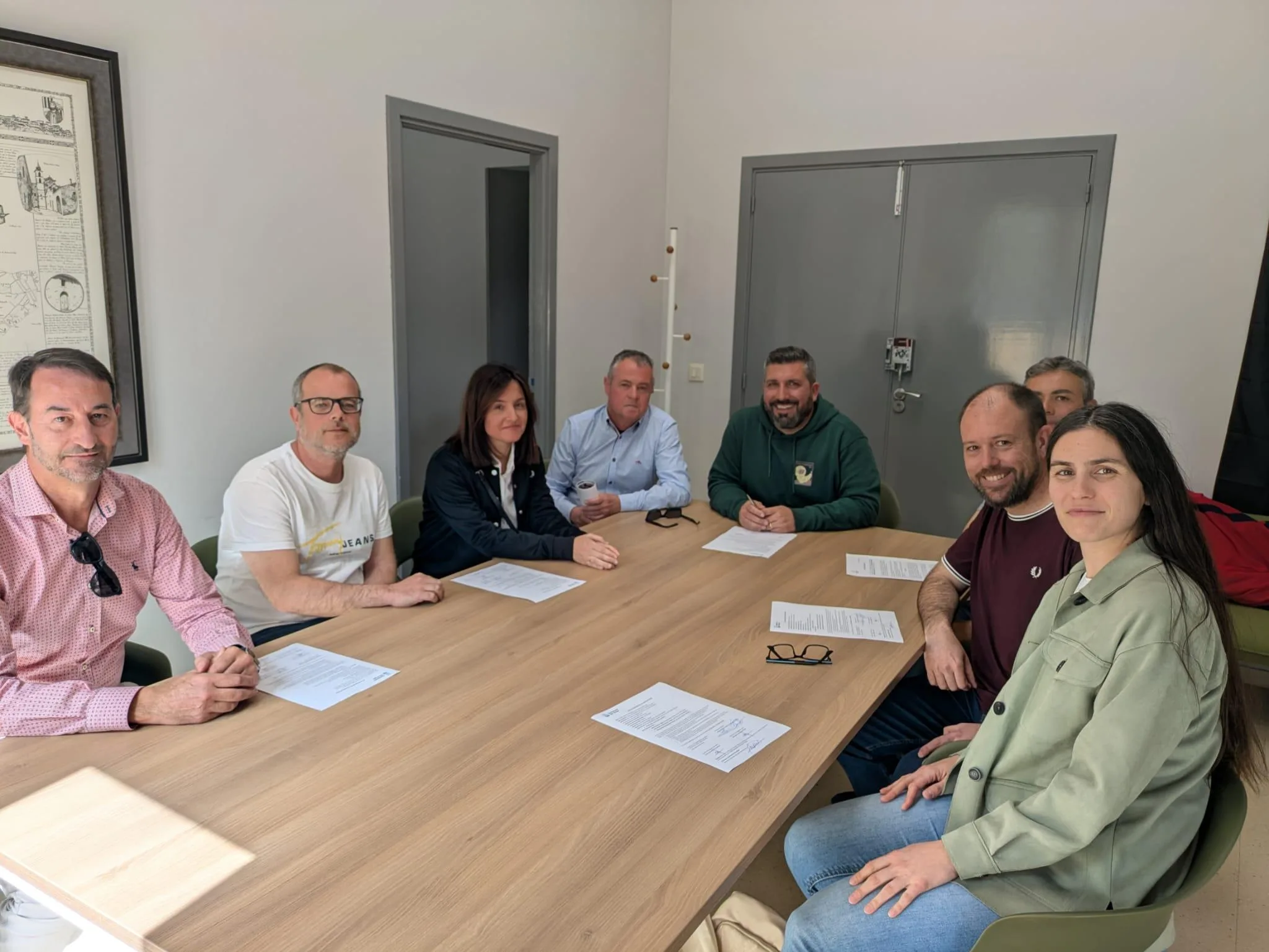 Grupo de personas reunidas en una mesa firmando documentos relacionados con la rehabilitación del Antic Ajuntament del Verger.