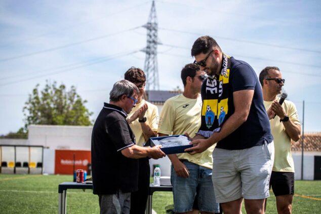 La Jornada Grogueta de la UD Ondarense reúne a aficionados y leyendas en Ondara 3 Imagen: Entrega de un premio a un miembro de la UD Ondarense durante un acto en un campo de fútbol.