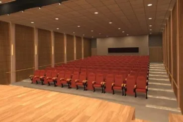 Render del interior del Salón de Actos Tina Bru con butacas rojas y paneles de madera tras la reforma.