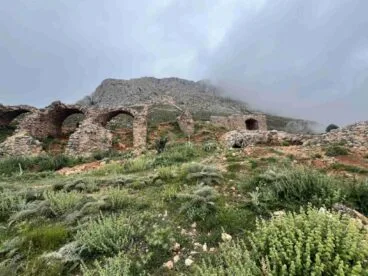 El Fort de Bèrnia y «su estado de ruina» entran en la «Lista Roja» de una asociación de defensa del patrimonio 1 Fotografía de las ruinas de piedra y arcos del Castillo de Bernia en la ladera de una montaña nublada.